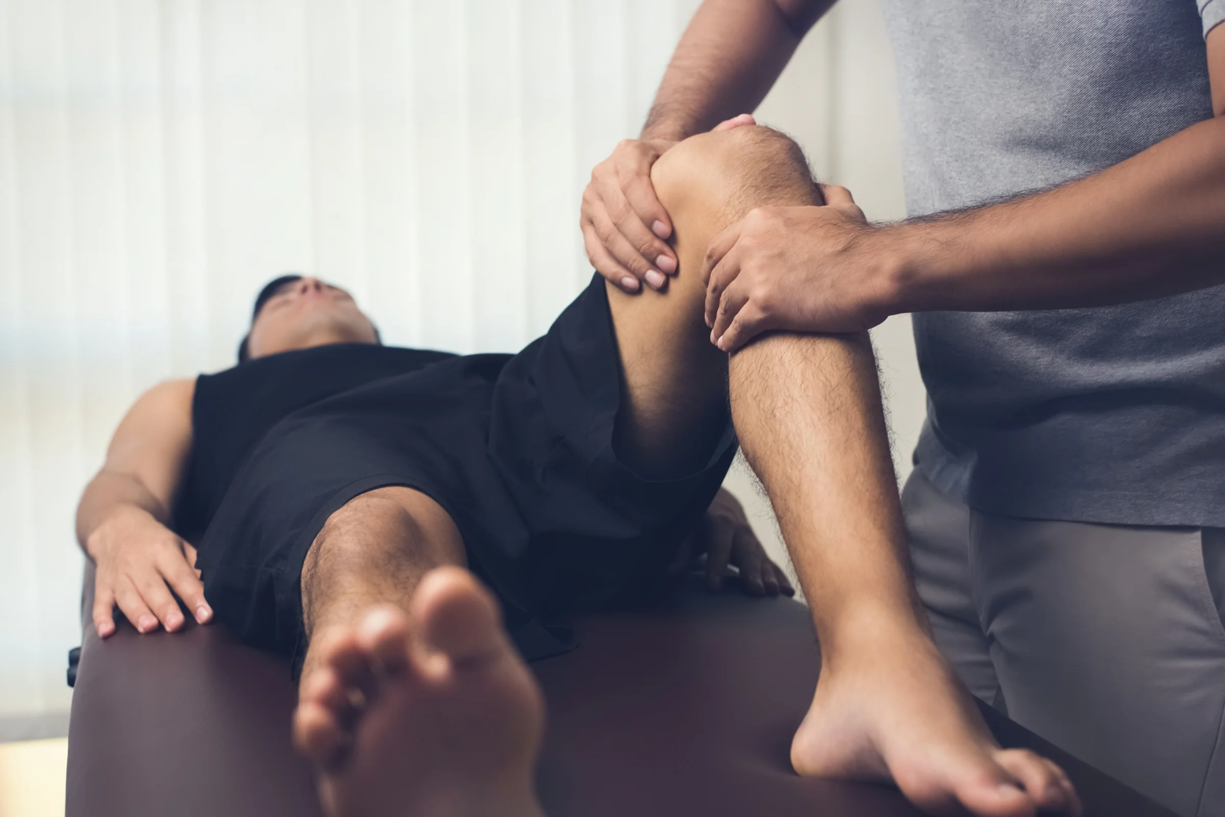 Physiotherapist treating athlete patient